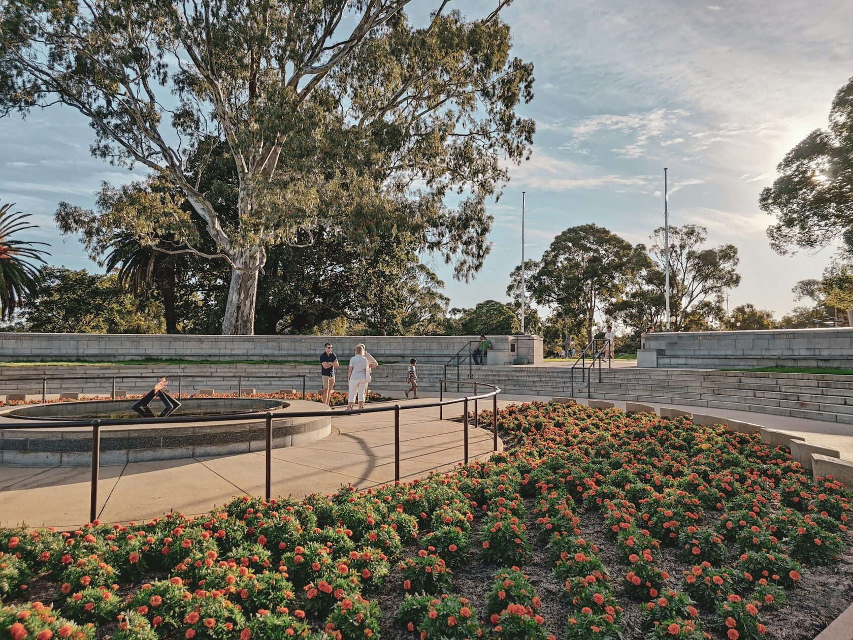 Wide view of a Perth garden with layered planting and a central lawn.